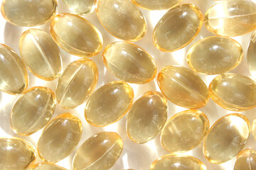 Shiny golden capsules of omega-3 fish oil rich in nutrients and health benefits.