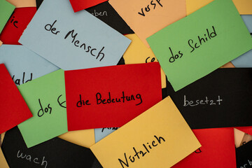 Close up seamless photo of colorful flash cards with handwriting german words as a concept of new...