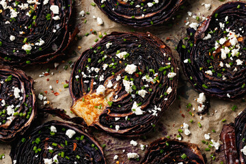 Baked red cabbage steaks with herbs and feta cheese