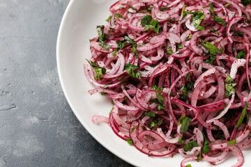 Sumac red onion salad in a white plate