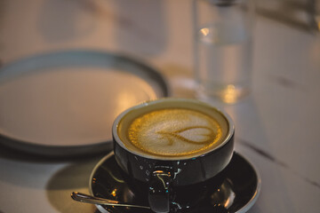 Coffee latte in a black cup..