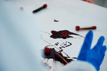 Scientist, hands and blood samples with mess of DNA for investigation, crime scene or decontamination at lab. Closeup, science and chemical biologist with spill or gloves for safety or disinfection