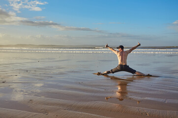 A man on the shores of the Atlantic Ocean enjoying the sunrise. Morocco