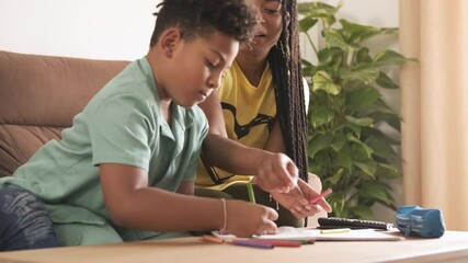 Siblings drawing together at home