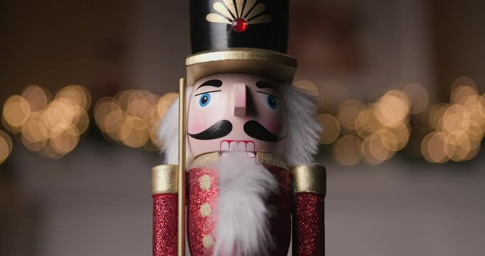 close up video of classic Nutcracker figurine, framed by twinkling bokeh lights, captures the timeless spirit of Christmas