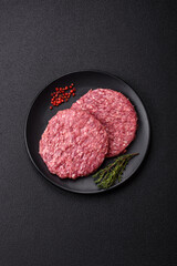 Fresh raw ground beef burger patty with salt and spices