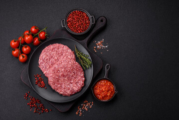 Fresh raw ground beef burger patty with salt and spices