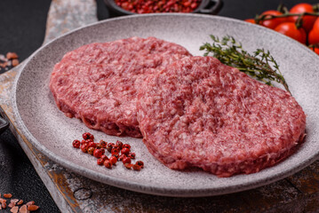 Fresh raw ground beef burger patty with salt and spices
