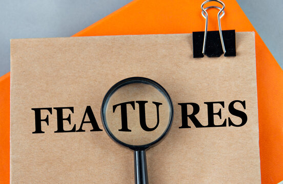 FEATURES - word on a brown sheet with a magnifying glass in the center