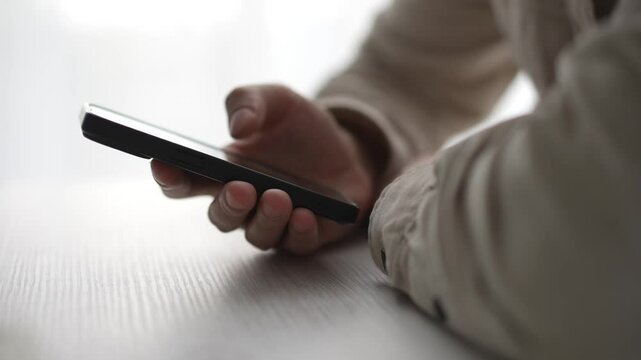 the phone is in the guy's hands.
A man uses a gadget.
Paner types a message on his smartphone.
Work, technology, smart, IT specialist, sms, screen