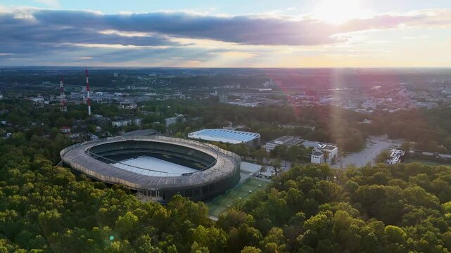 Kaunas Darius and Girenas football stadium, largest in Lithuania. Aerial 4K drone video footage of a multi-use stadium in Azuolynas oak park during a sunset