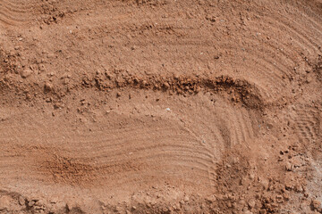 Background of beige, brown beach sand with natural pattern background. top view, flat lay. copy space, close up