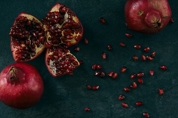 red ripe pomegranate fruits on dark background