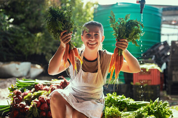 Happy woman, portrait and farmer with carrots for harvest, crops and organic production. Female...