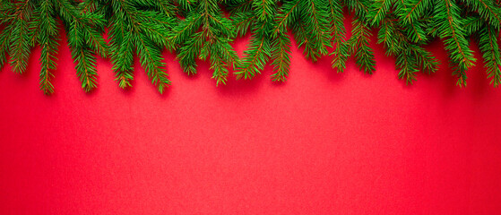 Christmas New year natural spruce branches border on red background, Happy New Year concept background wide