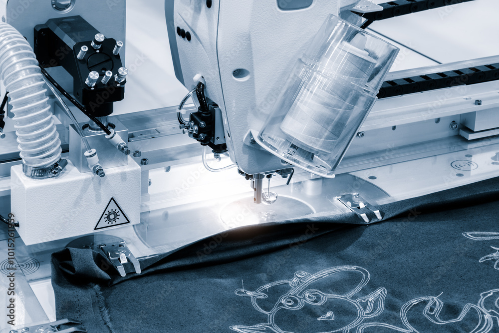Aufkleber a sewing machine is in use, with a piece of fabric being sewn. the machine is blue and white, and th