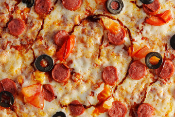 Freshly baked pepperoni pizza, generously layered with olives and tomatoes, emerges golden and crispy, inviting everyone to indulge in a delightful culinary experience.