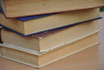 a stack of old books on the table. selective focus