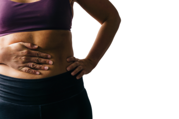 Isolated woman's abdomen with hand holding stomach