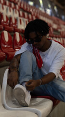 Young Man in Casual Outfit Looking Down in Urban Setting