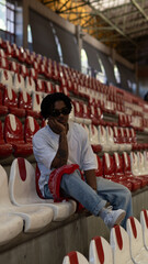 Young Man in Casual Outfit Looking Down in Urban Setting