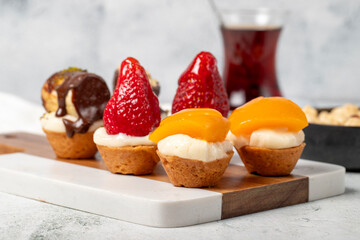Fruit tartlet dessert on gray background