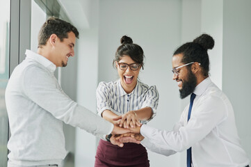 Business people, hand pile and celebration for agreement, motivation or office support. Group, employee and cheerful workers for team building, collaboration or partnership meeting for goals