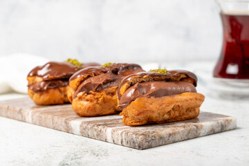 Chocolate eclair dessert on gray background