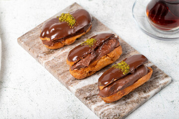 Chocolate eclair dessert on gray background