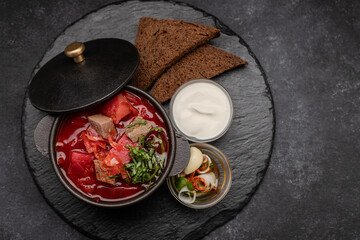 Red borscht with meat, sour cream and black bread