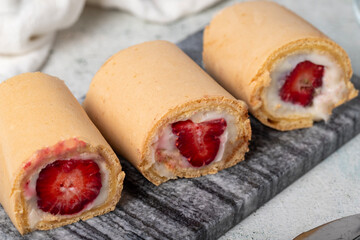 Strawberry roll dessert on gray background