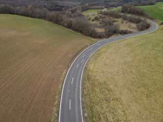 Aerial view of a curved road in the landscape in spring