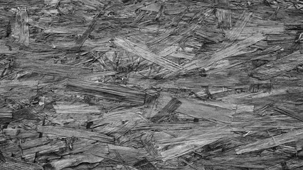 A pile of wood chips cray color texture background. The pile is made up of small pieces of wood