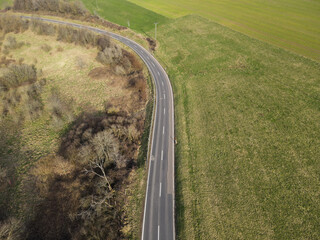 Aerial view of a curved road in the landscape in spring