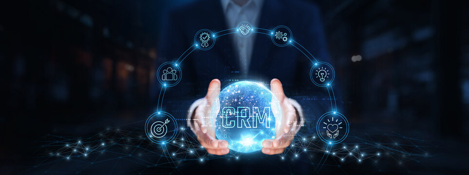 CRM (Customer Relationship Management): Businessman hands hold global CRM technology, data analytics, customer engagement, sales automation, lead management, marketing integration, customer support.
