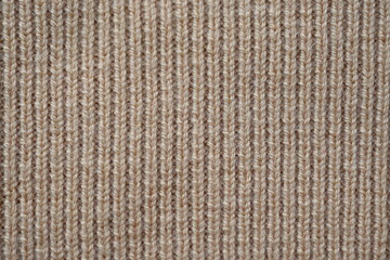  texture of knitted light brown sweater, close-up texture of beige knitted fabric, macro texture of tan knitted woolen clothes