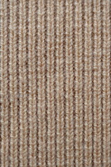  texture of knitted light brown sweater, close-up texture of beige knitted fabric, macro texture of tan knitted woolen clothes