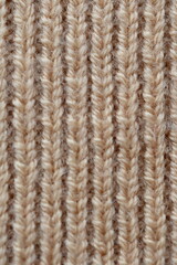  texture of knitted light brown sweater, close-up texture of beige knitted fabric, macro texture of tan knitted woolen clothes