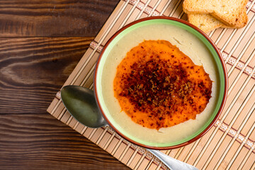 Delicious lentil soup with butter on wooden background