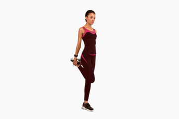 Fitness Girl Stretching Leg Before Workout Over White Studio Background. Warm Up Basics. Isolated, Full Length