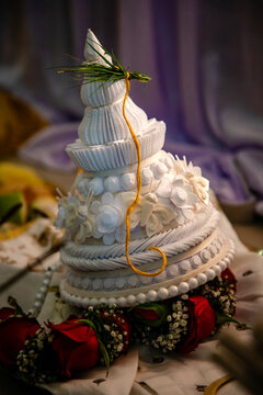 A topor is a type of conical headgear, made of white sholapith, traditionally worn by grooms as part of the Bengali Hindu wedding ceremony. Bengali wedding rituals, puja arrangement background