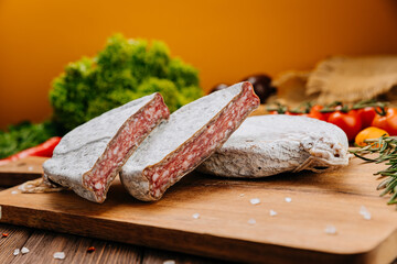 Dry-cured salami on board, ideal for rustic charcuterie presentations and gourmet food styling