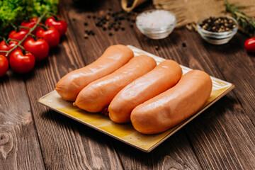Four fresh sausages on plate, perfect for food photography, advertising, or culinary projects