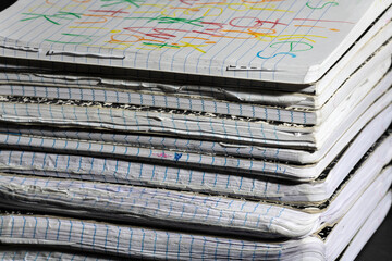Stack of Worn Notebooks. A stack of well-used notebooks with worn edges and colorful scribbles on...