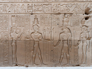Egyptian hieroglyphic engravings on the stone walls of the temple of the God Horus in Edfu Egypt