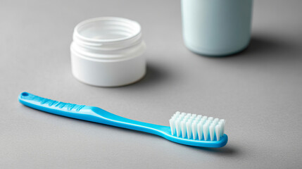 "A plastic toothbrush and toothpaste arranged on a light background in a flat lay style, with space available for text."




