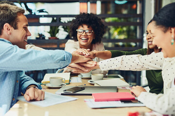 Business people, coffee shop and hands stack in meeting, team planning and communication at cafe. Employees, restaurant and huddle for collaboration in pile, brainstorming and proposal development