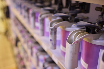 Colorful paint containers are arranged in a studio, showcasing creativity and artistic detail