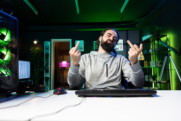 Smug gamer celebrating winning online multiplayer game, killing all enemies, throwing middle finger...