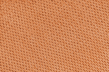 Texture of orange jacquard fabric of diagonal rough weave cloth structure macro background